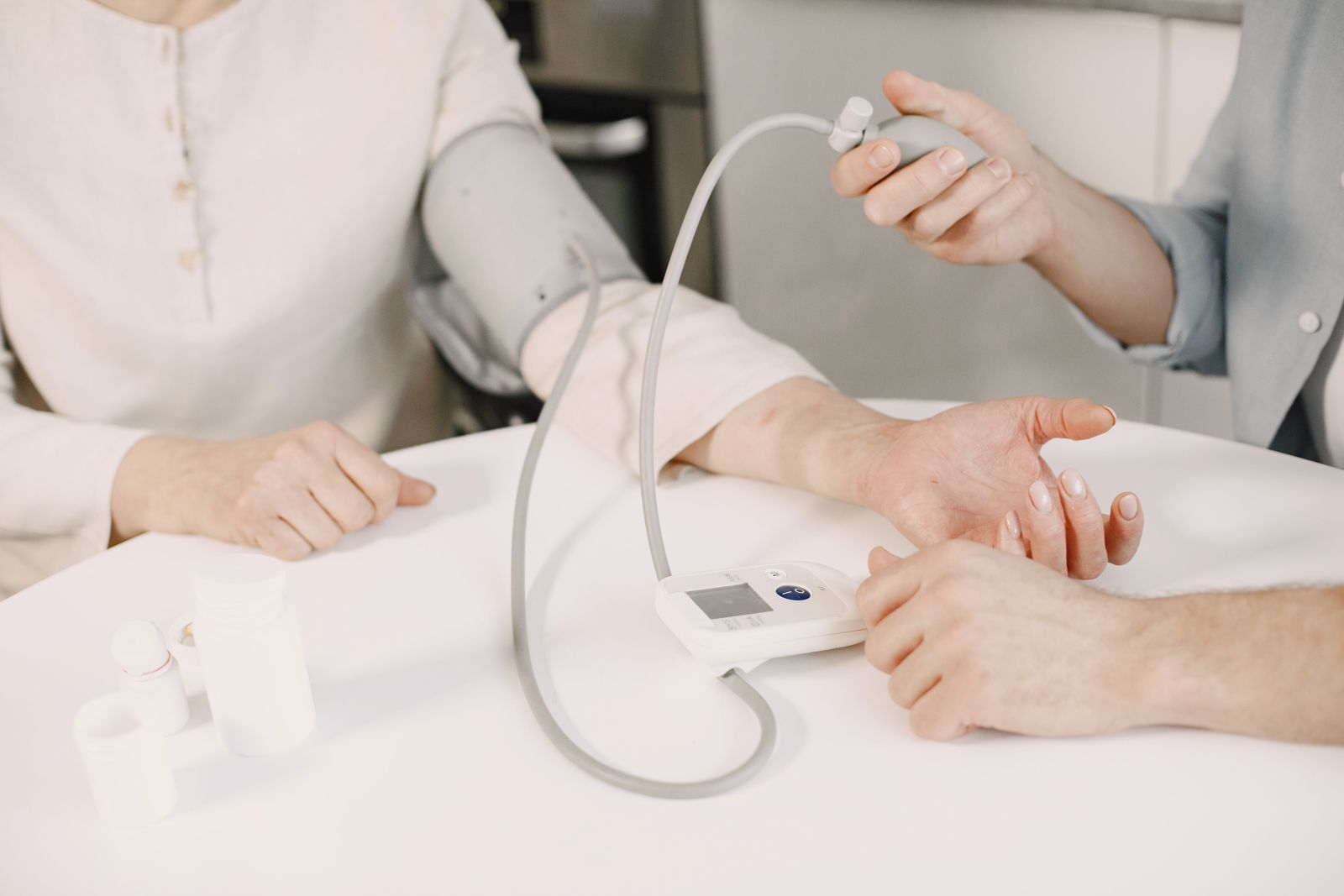 Nurse checking a patient blood pressure at home