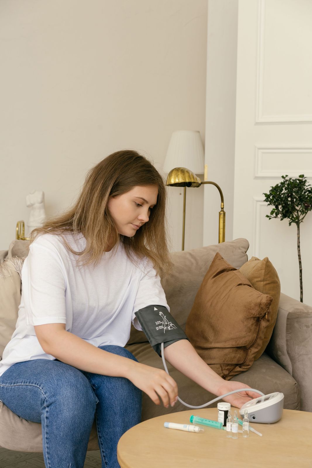 A woman checking her blood pressure at home